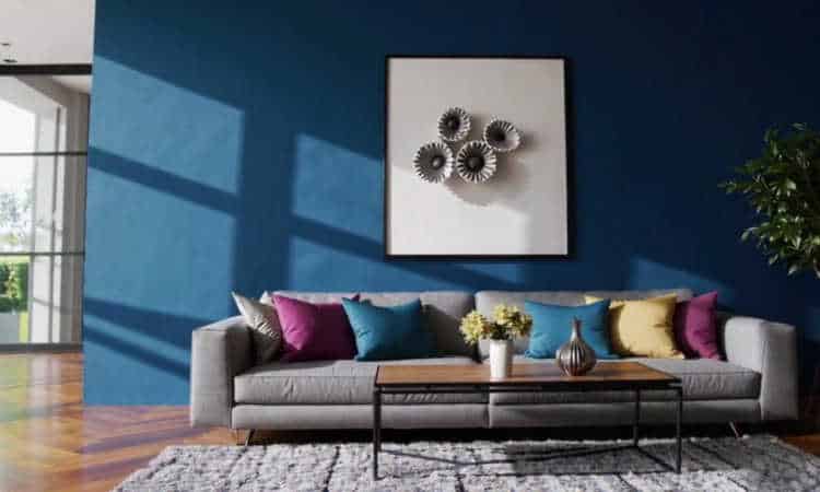 Living room with a bold blue accent wall behind a modern sofa.