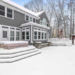 A beautifully painted grey house in Cleveland, Ohio, surrounded by snow in winter.