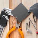 A set of work tools on a wooden background, perfect for DIY home improvement projects.