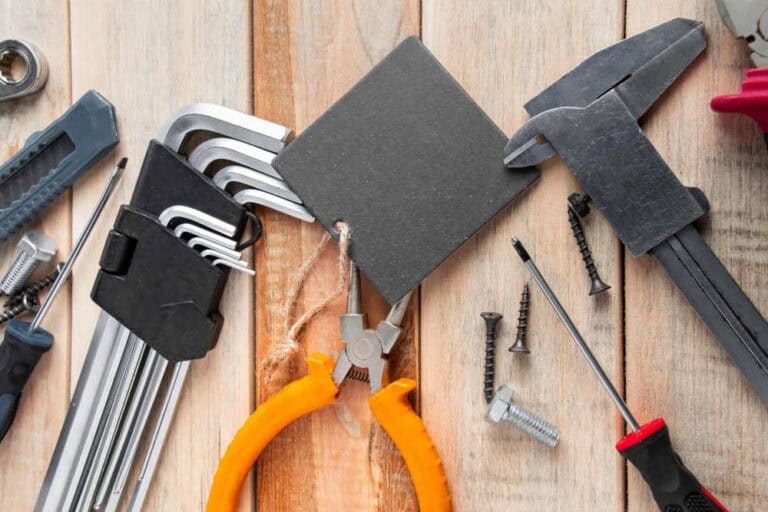 A set of work tools on a wooden background, perfect for DIY home improvement projects.