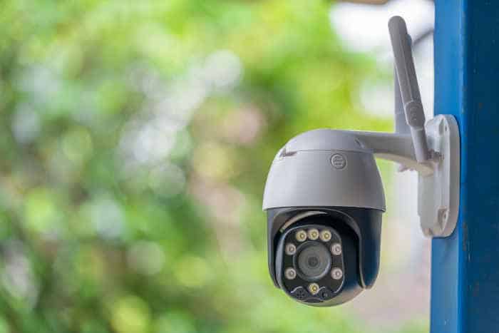 A smart security camera mounted on the side of a home for real-time monitoring.