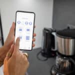 Smartphone controlling multiple smart home devices, showcasing home automation.