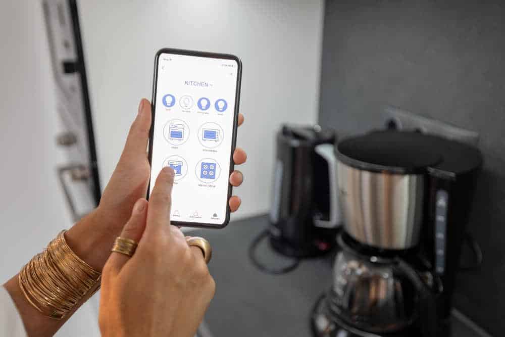 Smartphone controlling multiple smart home devices, showcasing home automation.