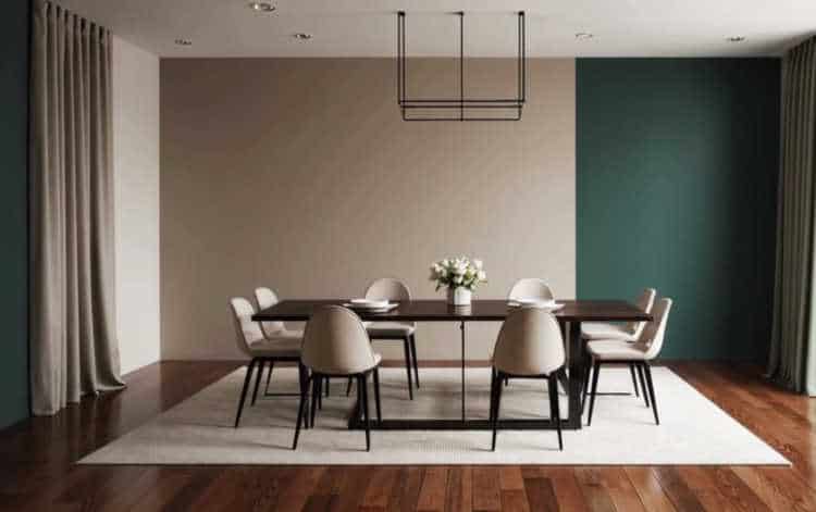 A modern dining room with a two-tone wall in beige and emerald green.