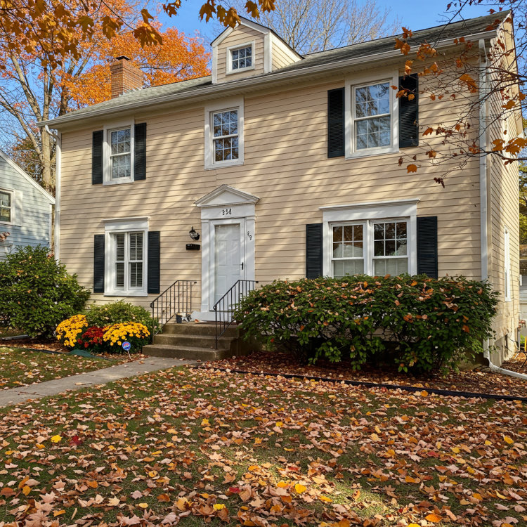 Exterior trim painting on Ohio home with fresh white accents against neutral siding