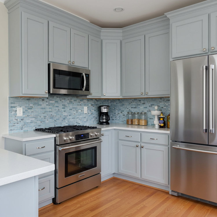 Bright modern Ohio kitchen with refinished cabinets, warm paint colors, and updated lighting for a fresh, welcoming look.