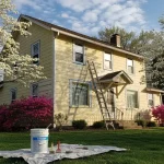 Spring exterior painting prep on a Northeast Ohio home with ladder and paint supplies ready for the season