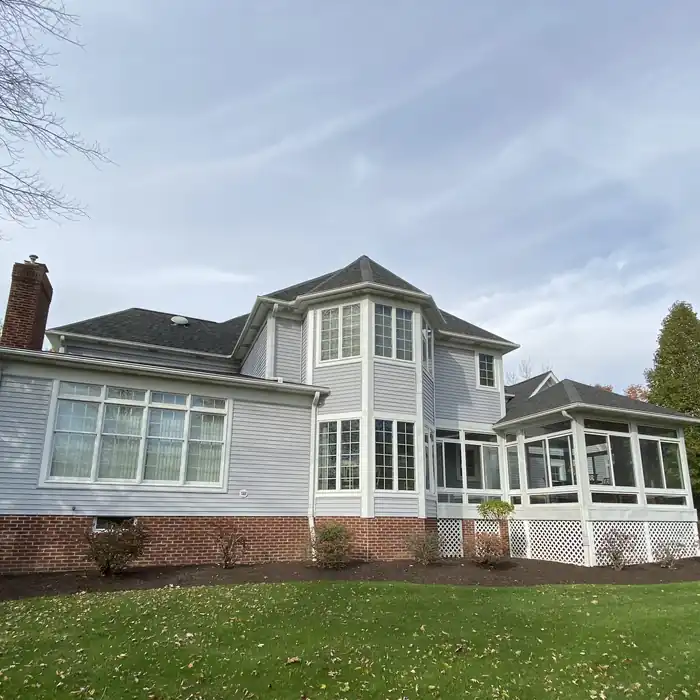 Gray exterior home with brick base and white trim painted by Crocker Home Painting Company