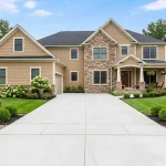 Light gray concrete driveway leading up to a home in Ohio