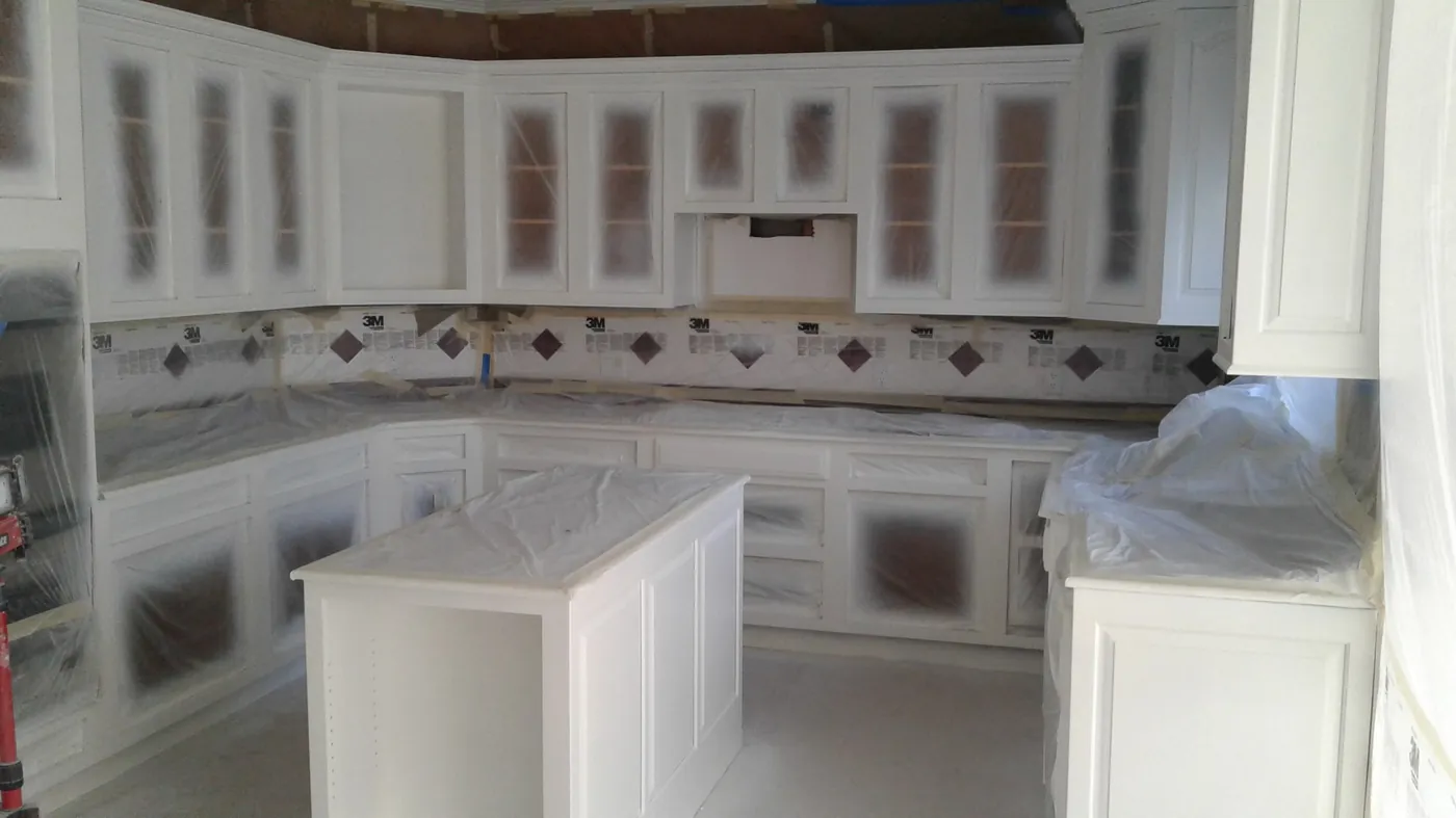 White kitchen cabinets being painted in place by Crocker Home Painting in Westlake, Ohio
