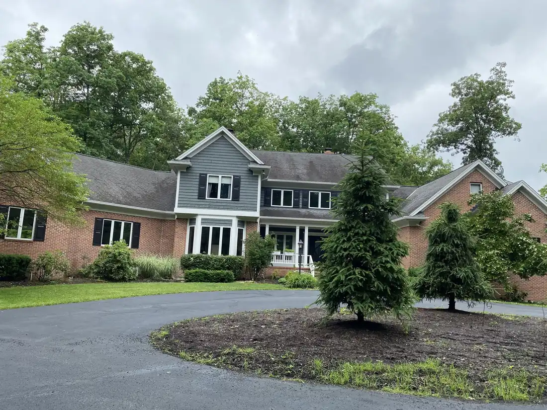 Brick and gray siding two-story home exterior after painting by Crocker Home Painting in Westlake, Ohio
