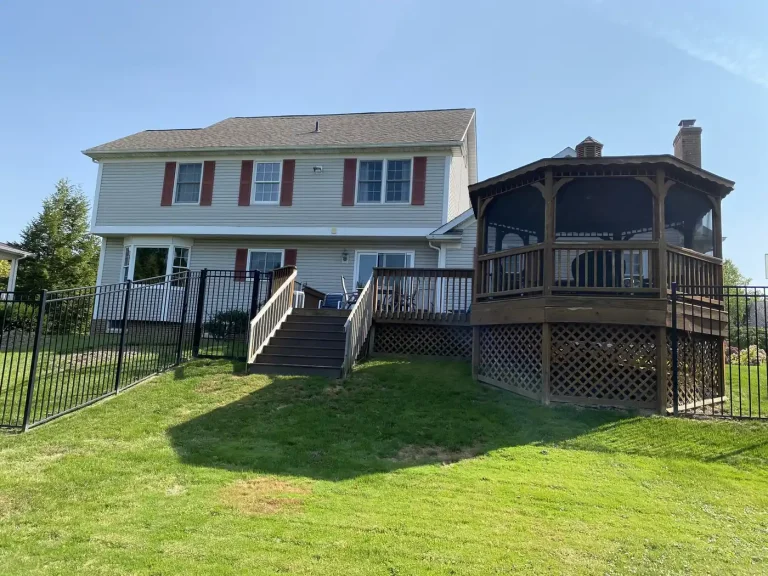 Home exterior with a covered porch and deck after repainting