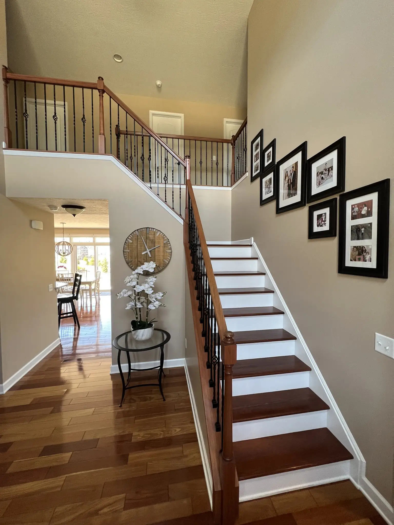 Staircase hall with a gallery wall of framed photos