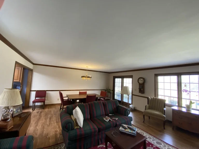 Freshly painted white ceiling with dark wood crown molding